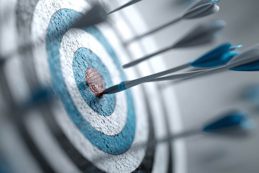 target with arrows randomly sticking out. None within the bullseye. inconsistent performance concept.